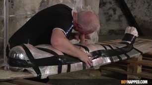 Restrained twink receives treat from dom