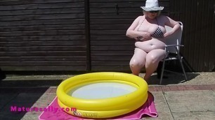 Mature with massive tits in the smallest bikini by the pool